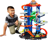 Garage Hot Wheels avec circuit de course à plusieurs étages, attaque de T-Rex et 2 voitures – Espace pour plus de 100 véhicules, à partir de 5 ans